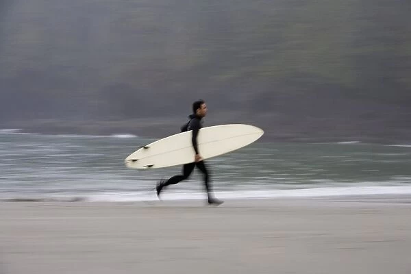 A Surfer, Running With Board Along The Shoreline