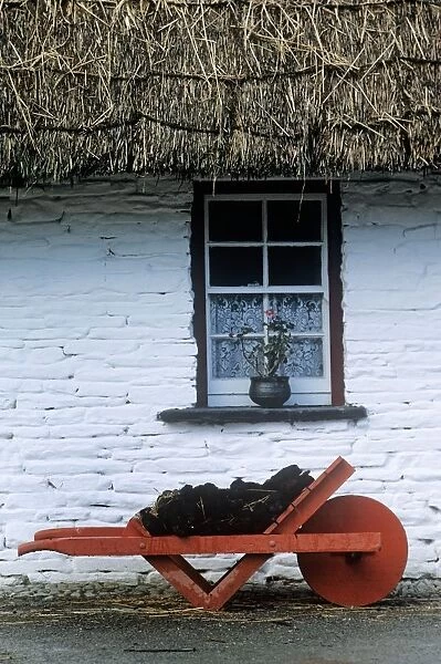 Wheelbarrow In Front Of A Window Of A Cottage, Bunratty Folk Park, Bunratty, County Clare, Republic Of Ireland
