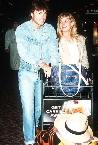 Actor Nick Berry arrives at Heathrow Airport with model Rachel Roberts May