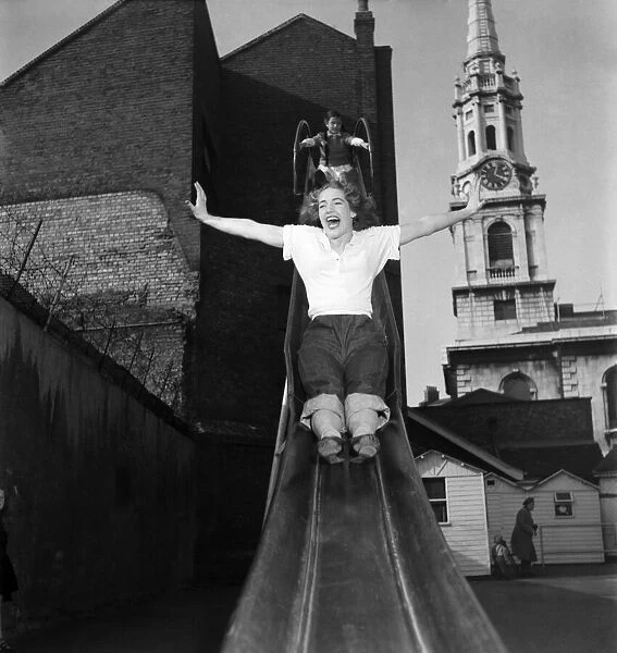 Actress Audrey Freeman -stretches out her arms as she takes a go on a slide