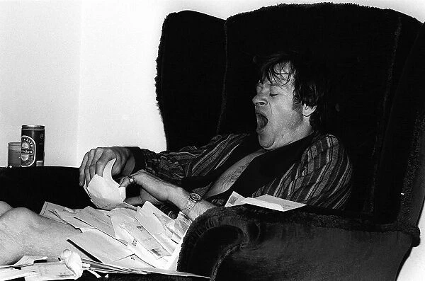 Alex Higgins World Snooker Champion 1982 has a yawn at home after reading all