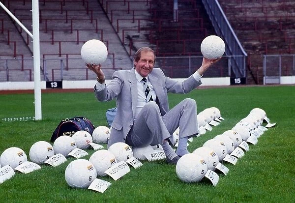 Ally MacLeod sitting amongst rows of balls. January 1989