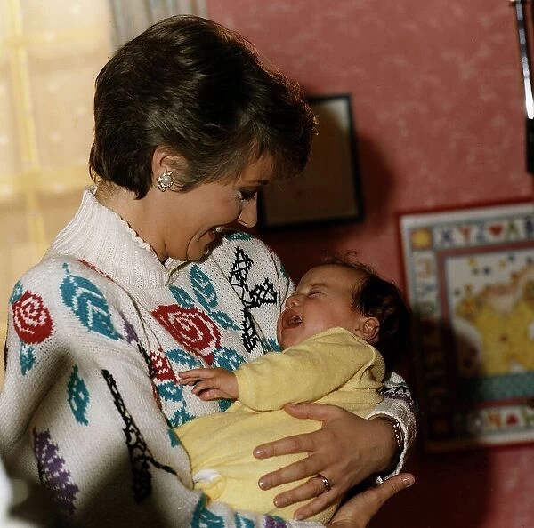 Anne Diamond cuddles tiny Clemency one of the babies used in the ad