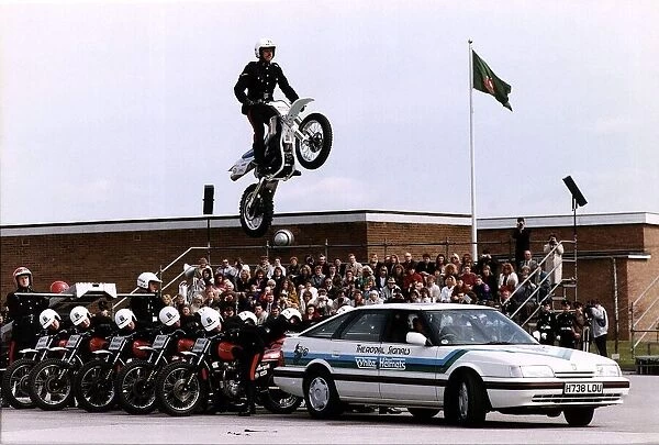 Army Regiments Royal Signals White Helmets on motorbikes doing a stunt over a car