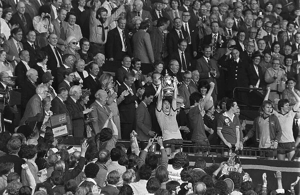 Arsenal captain Pat Rice holds up FA Cup after Arsenal had beaten Manchester United at