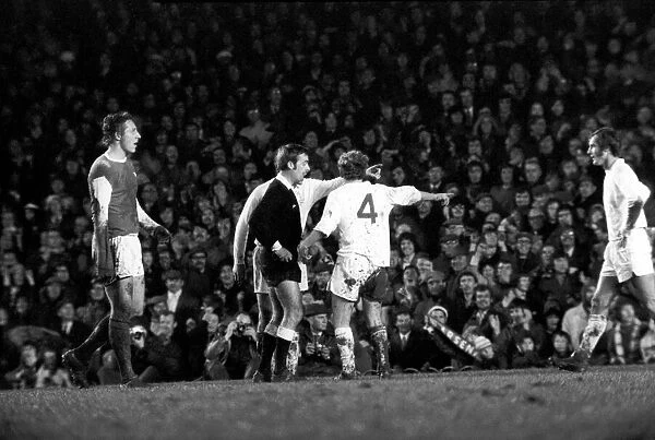 Arsenal vs. Leeds. Leeds players including Peter Lorimer argue with the referee after a