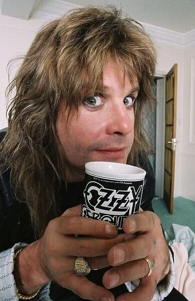 Black Sabbath singer Ozzy Osbourne enjoying a drink form his personalised mug at his home