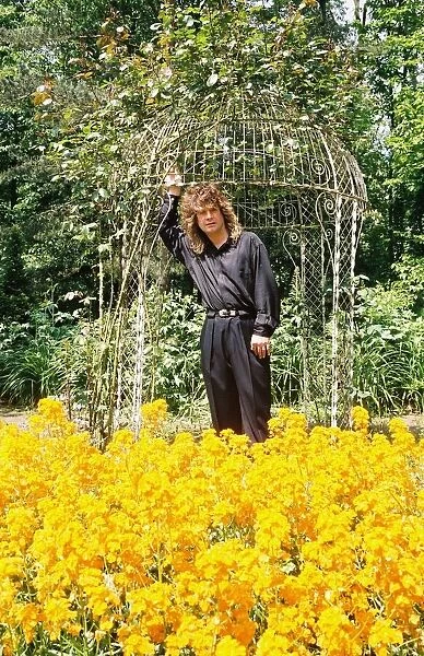 Black Sabbath singer Ozzy Osbourne amongst the flowers in the garden of his home