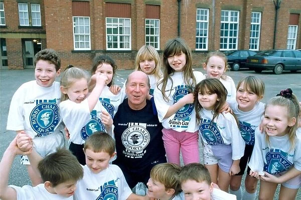 Bobby Charlton with children from Cavendish First School in Ashington in January 1992