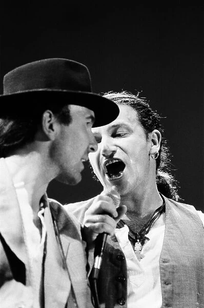 Bono onstage singing with The Edge during U2s concert in Cork