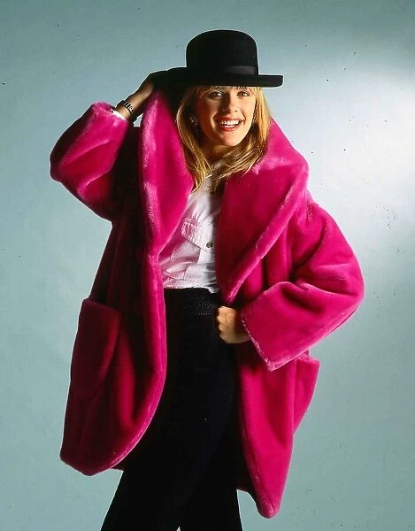 Carol Smillie model TV presenter wearing pink fake fur coat and black hat
