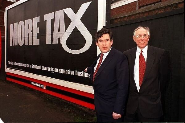 Chancellor Gordon Brown March 1999 with Donald Dewar pointing at poster about SNP