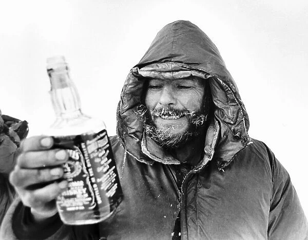 Charles Burton North Pole Expedition takes a rest with a drink from a bottle of Jack