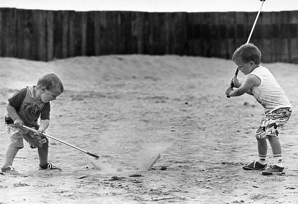 Children practise their golf swing on Ainsdale Beach, Southport