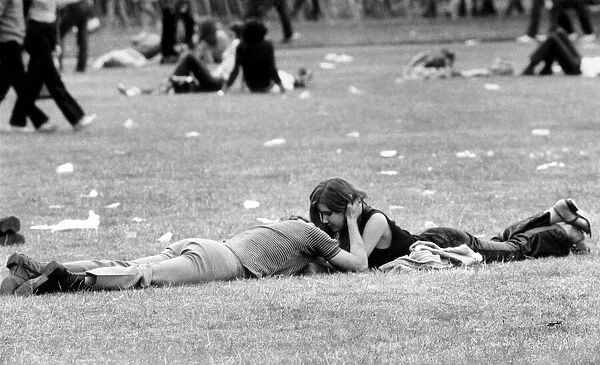 A couple enjoying the open air and the music as well as each others company