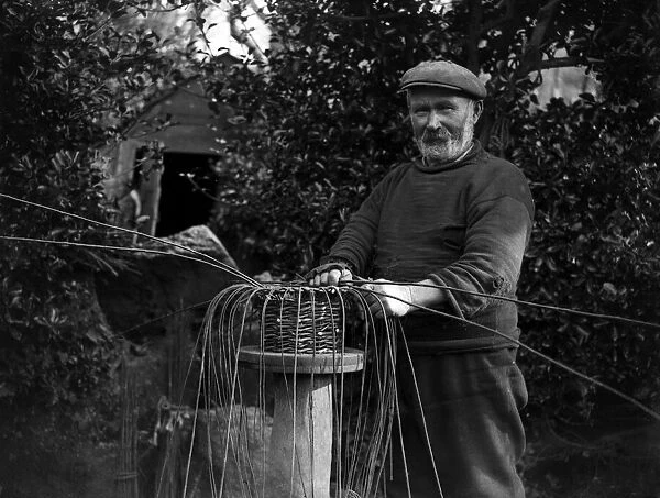 The crab pot industry at Penberth, Cornwall. Bending the willows into shape