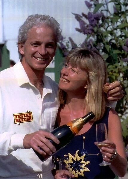 David Gower former cricket player for Hampshire CCC pours a glass of Champagne for his