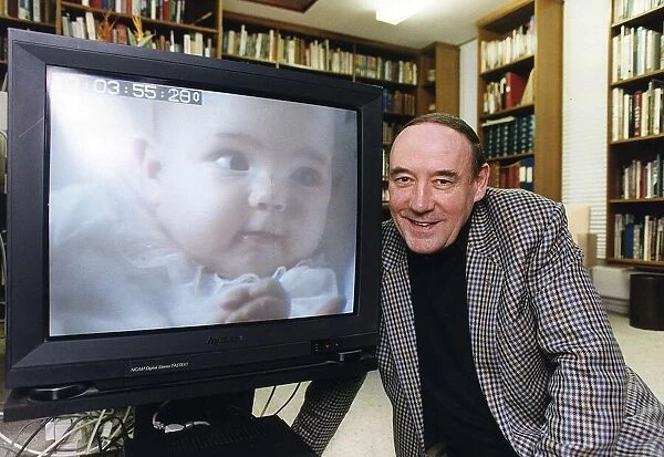 Desmond Morris anthropologist tv presenter baby watching at his home in Oxford