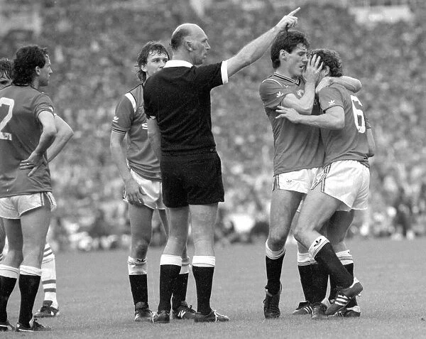 Distraught Manchester United footballer Kevin Moran is consoled by teammate Frank