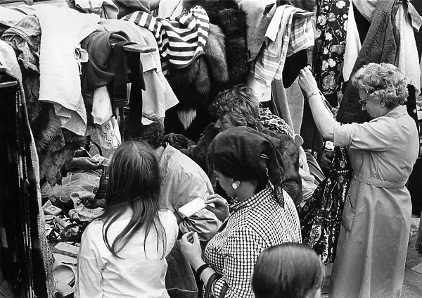 Eager shoppers rumage around one of the clothing stall in London