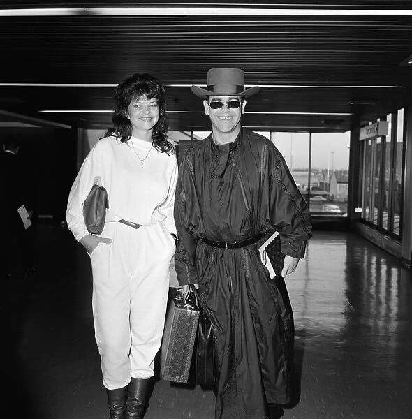 Elton John and his new wife Renate arriving at Heathrow Airport from Hong Kong