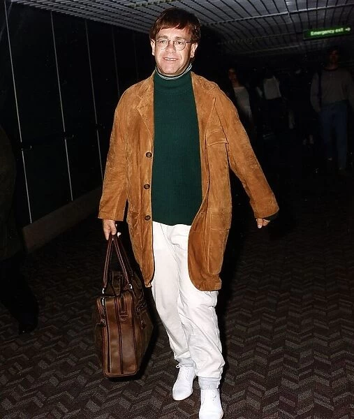 Elton John singer arriving at an airport