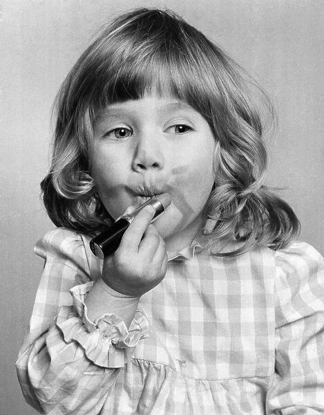 Emma Varsanyi. March 1976 P034769 Little girl putting on lipstick