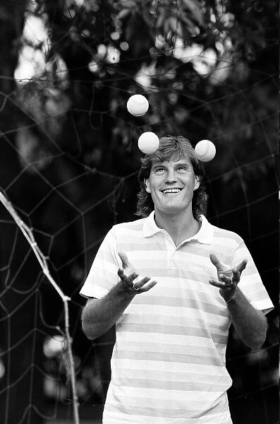 England footballer Glenn Hoddle juggling tennis balls as the team relaxes at their base