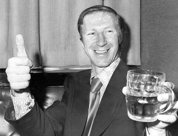 An exuberant Jack Charlton of Leeds United celebrates with a pint
