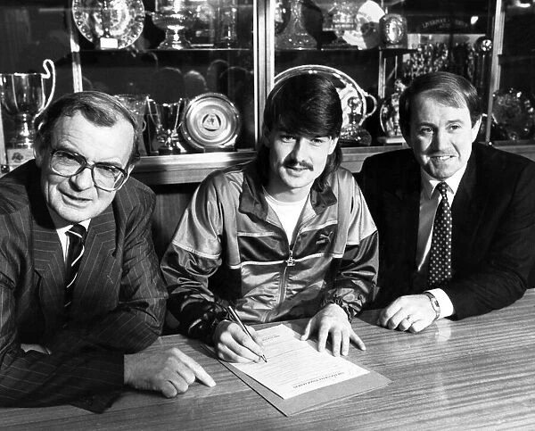 Footballer Ian Snodin pictured signing for Everton watched by manager Howard Kendall