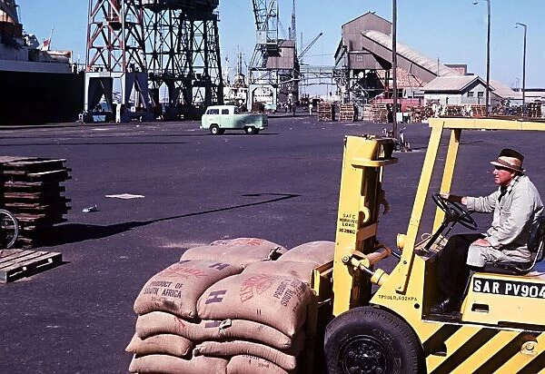 Forklift truck loading fishmeal onto a ship at Docks Walvis Bay