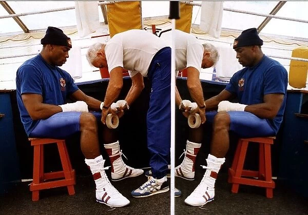 Frank Bruno Boxer sitting on stall having a bandage put on his hands
