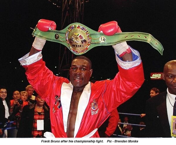 Frank Bruno hold aloft his WBC World Boxing Council Championship belt after defeating