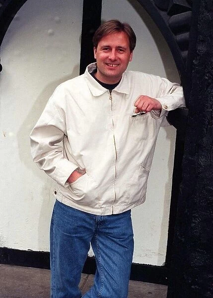 Gary Webster actor leaning against wall white jacket denims clenched fist April 1997