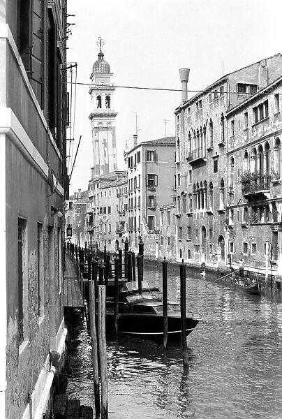 General scene of Venice. A gondolier makes his way down on one of the lesser canals