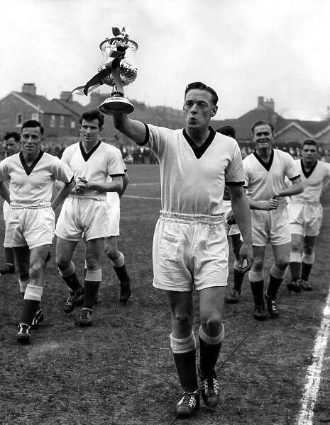 Giant-killersO skipper Frank Marshall holds the beribboned Cup aloft after