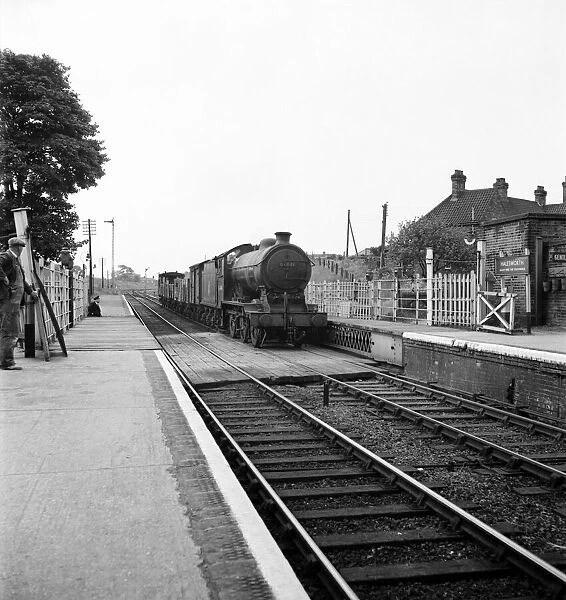 Goods train pulls into the railway station at Halesworth Suffolk. June 1952 C3365