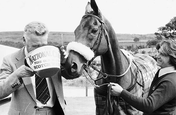 Grand National winner Red Rum with trainer Ginger McCain drinking from bucket 26th