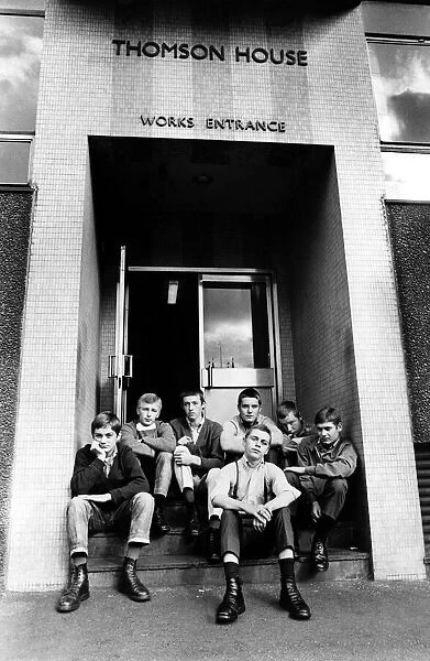 A group of skinheads sitting on the steps of Thomson House, works entrance