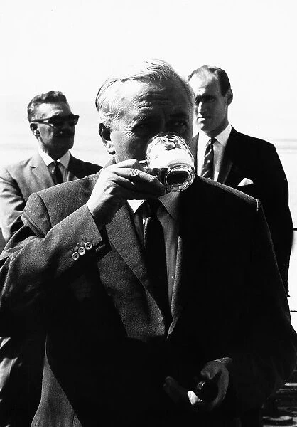 Harold Wilson taking a drink of Beer