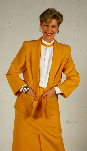 Harriet Buchan actress May 1987 wearing yellow jacket skirt suit and white blouse shirt