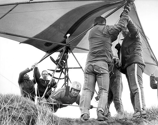 Helping hands get Gordon Smith ready to take to the air in his Hang Glider in April 1978