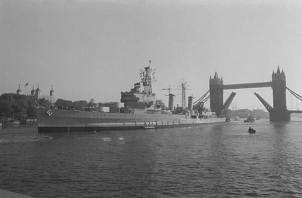 HMS Belfast sailing up the Thames 1971 passing through Tower Bridge to her mooring