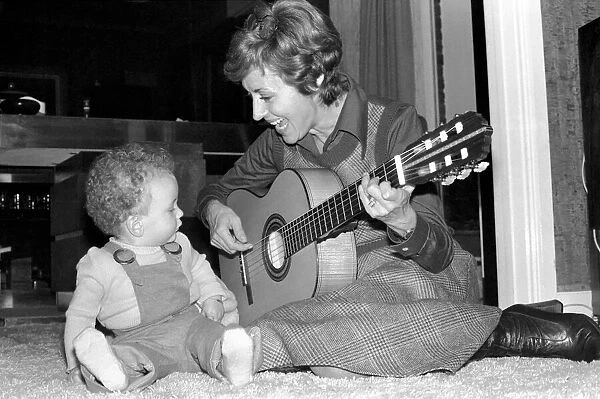 International singer star: Caterina Valente serenades her son. February 1975 75-00827-007