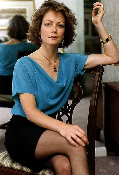 Jenny Seagrove Actress sitting on a Chair with her hand resting on the back pictured in