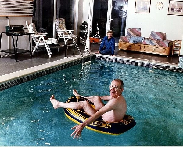 Jim Bowen TV Presenter Bullseye at home in his swimming pool with his wife Phyllis Bowen