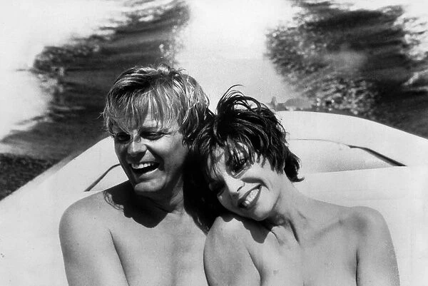 Joan Collins actress and her fiancee Peter Holm cuddle up together on a boat trip during