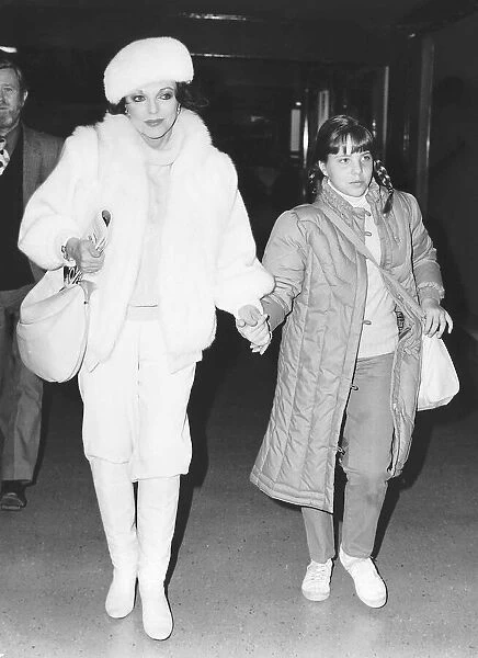 Joan Collins actress leaves Heathrow Airport with daughter Katy in January 1984