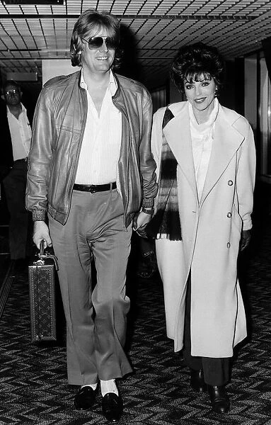 Joan Collins British actress arrives at Heathrow with husband Peter in April 1986