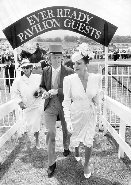 JOAN COLLINS AND HUSBAND PETER HOLM ARRIVING AT EPSOM RACECOURSE 01  /  06  /  1986